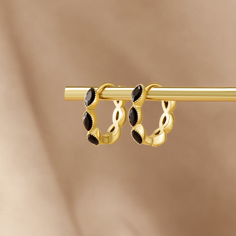 Onyx Tiny Hoop Earrings, pair of gold hoops with black marquise stones, hanging on a gold rod