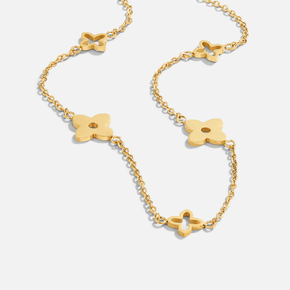 Tori Petal Necklace, gold chain necklace with four-petal flower motifs on white