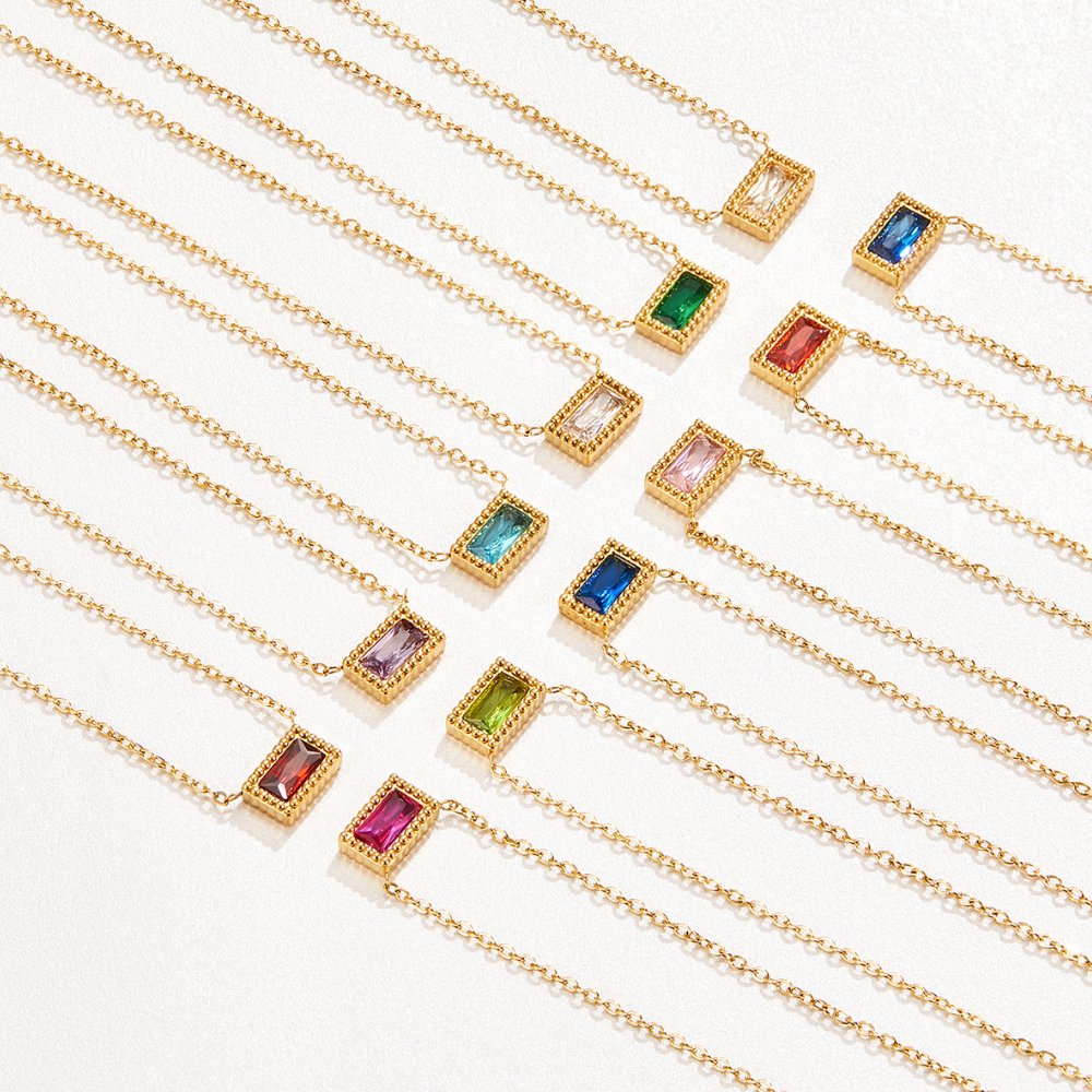 Baguette Birthstone Necklace, many necklaces laid out in a diagonal row, varied gemstone