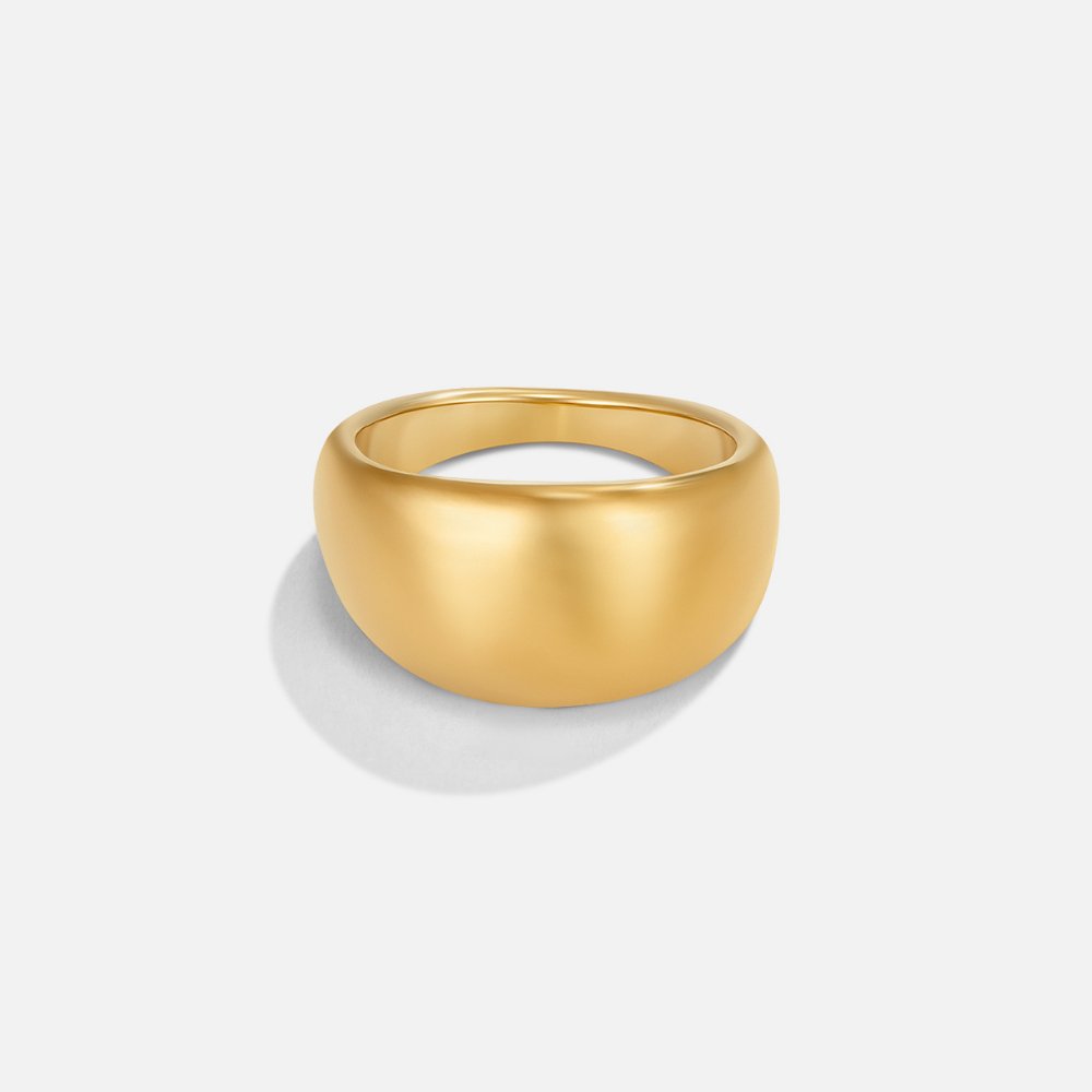 Celia Chunky Gold Ring, wide polished gold dome ring on a plain light background