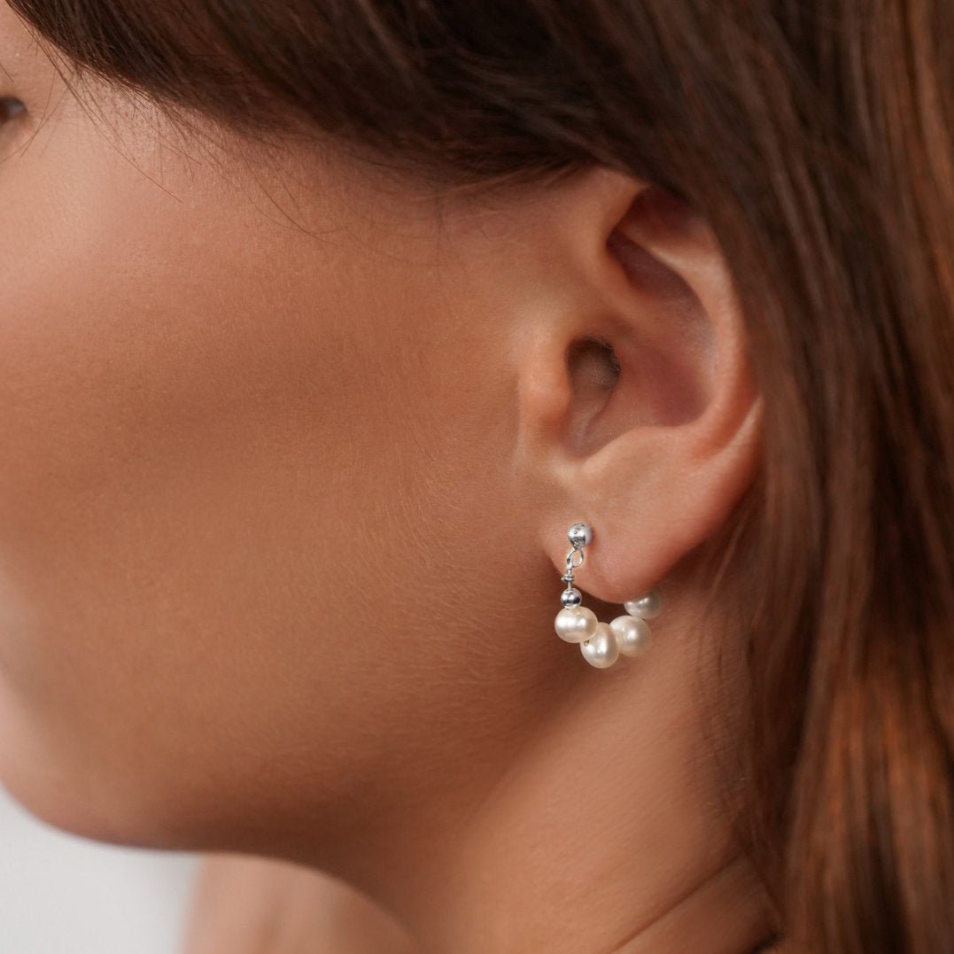 Celine Pearl Silver Hoop Earrings, worn in an ear, small silver hoop strung with white pearls