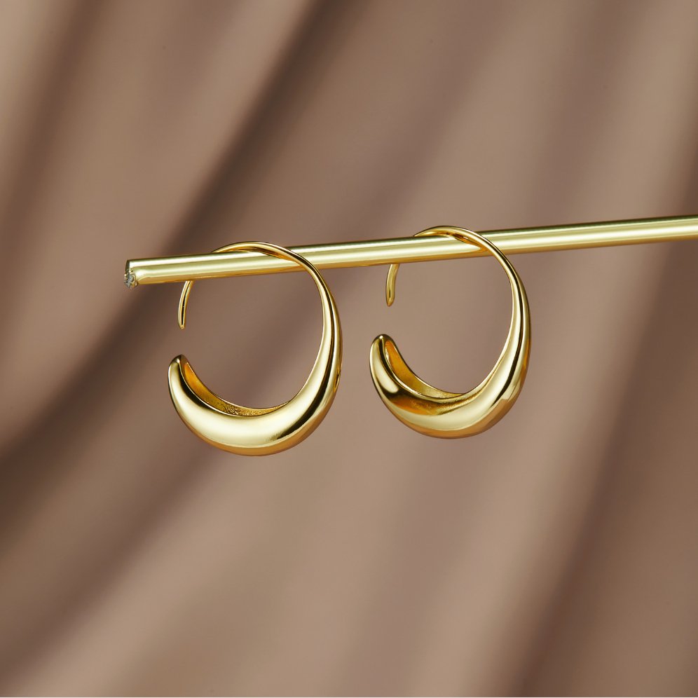 Classic Drop Hoop Earrings, pair of gold crescent hoop earrings hanging from a gold rod