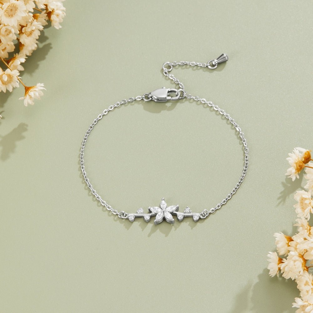 Crystal Flower Silver Bracelet, laid flat on sage green with dried white flowers, silver chain