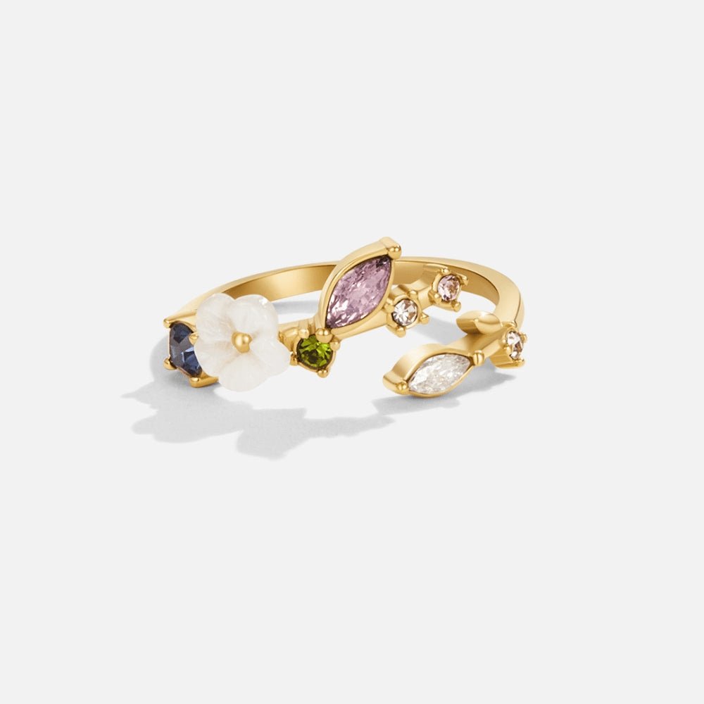 Crystal White Blossom Ring Gold, gold open ring on white background with pink, green and blue stones and a white flower