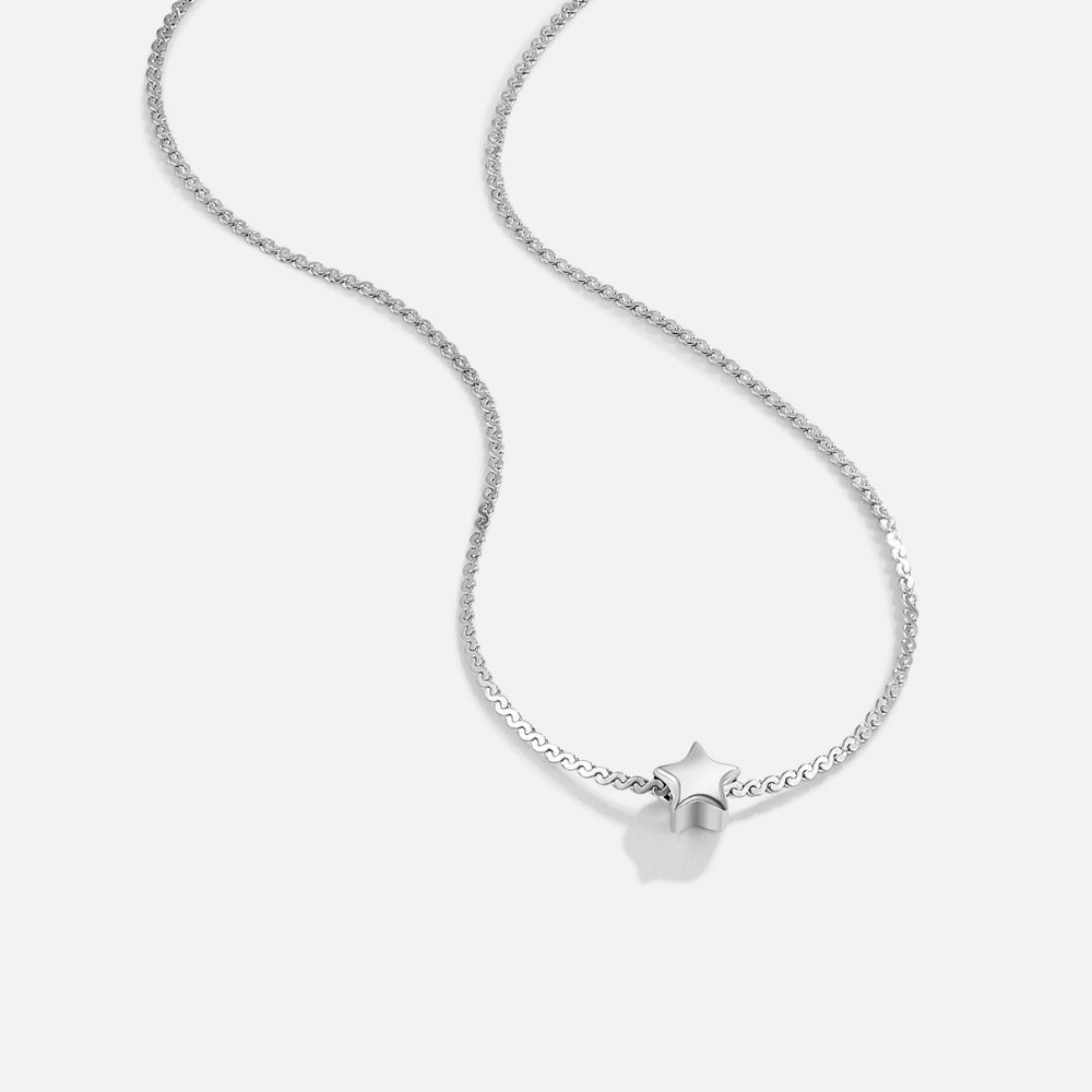 Dainty Star Silver Necklace, silver chain necklace laid out on white, with a small star pendant