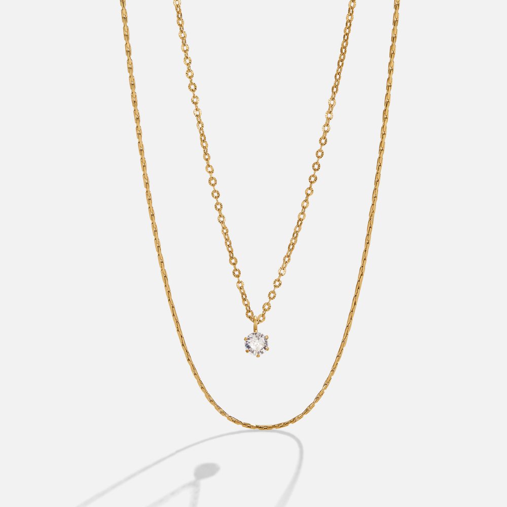 Dina Crystal & Gold Layered Necklace, two gold necklaces layered, one with a round crystal pendant