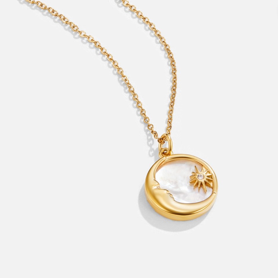 'Dreaming in the Clouds' Moon & Star Necklace, laid flat on white, gold pendant with