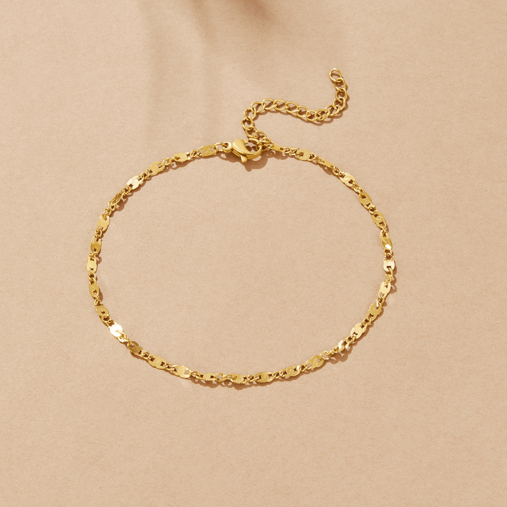 Elise Gold Anklet, laid flat in a circle on a beige background, gold chain with lobster clasp