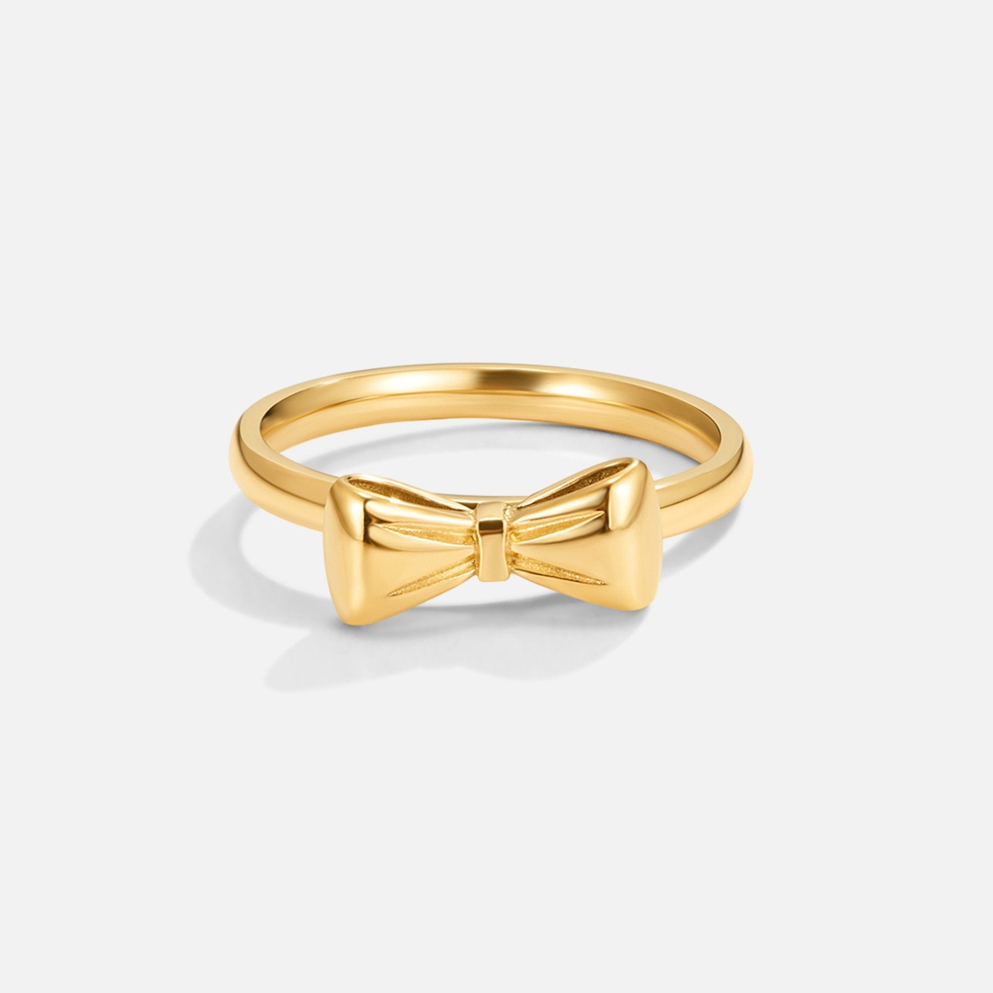 Ellie Gold Bow Ring, gold ring with a raised bow motif on a plain white background