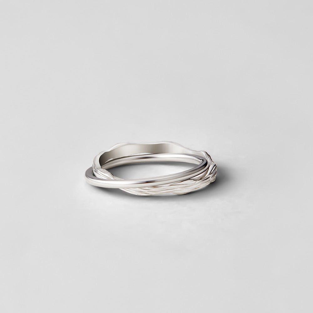 Forever Entwined Silver Ring, three silver bands intertwined, one smooth and one textured, on grey