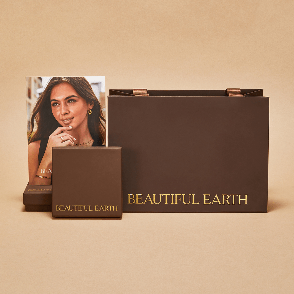 Gift Packaging, brown gift bag, small box and card on beige backdrop