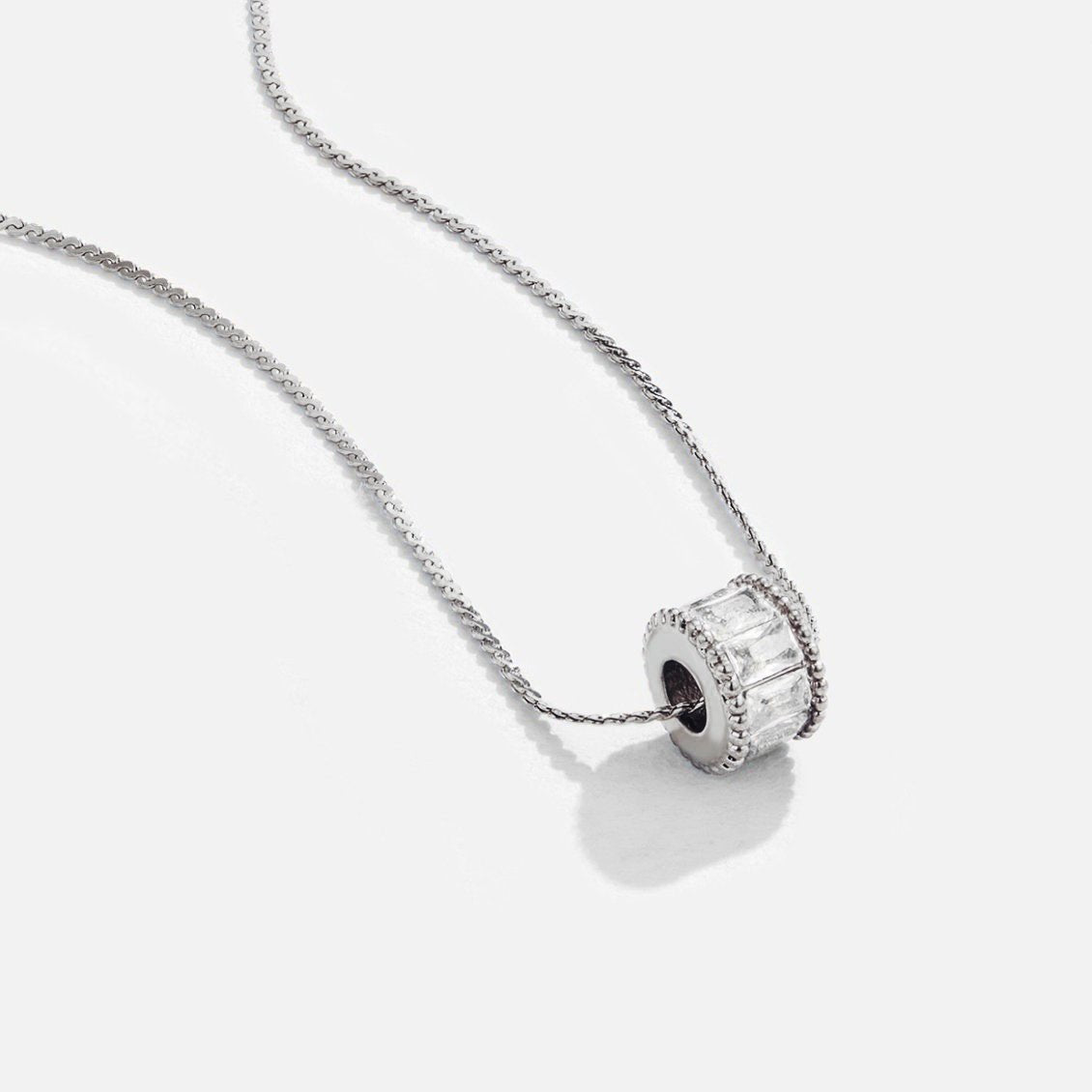 Gigi Crystal Silver Necklace, silver chain with a crystal-set roller bead pendant on white