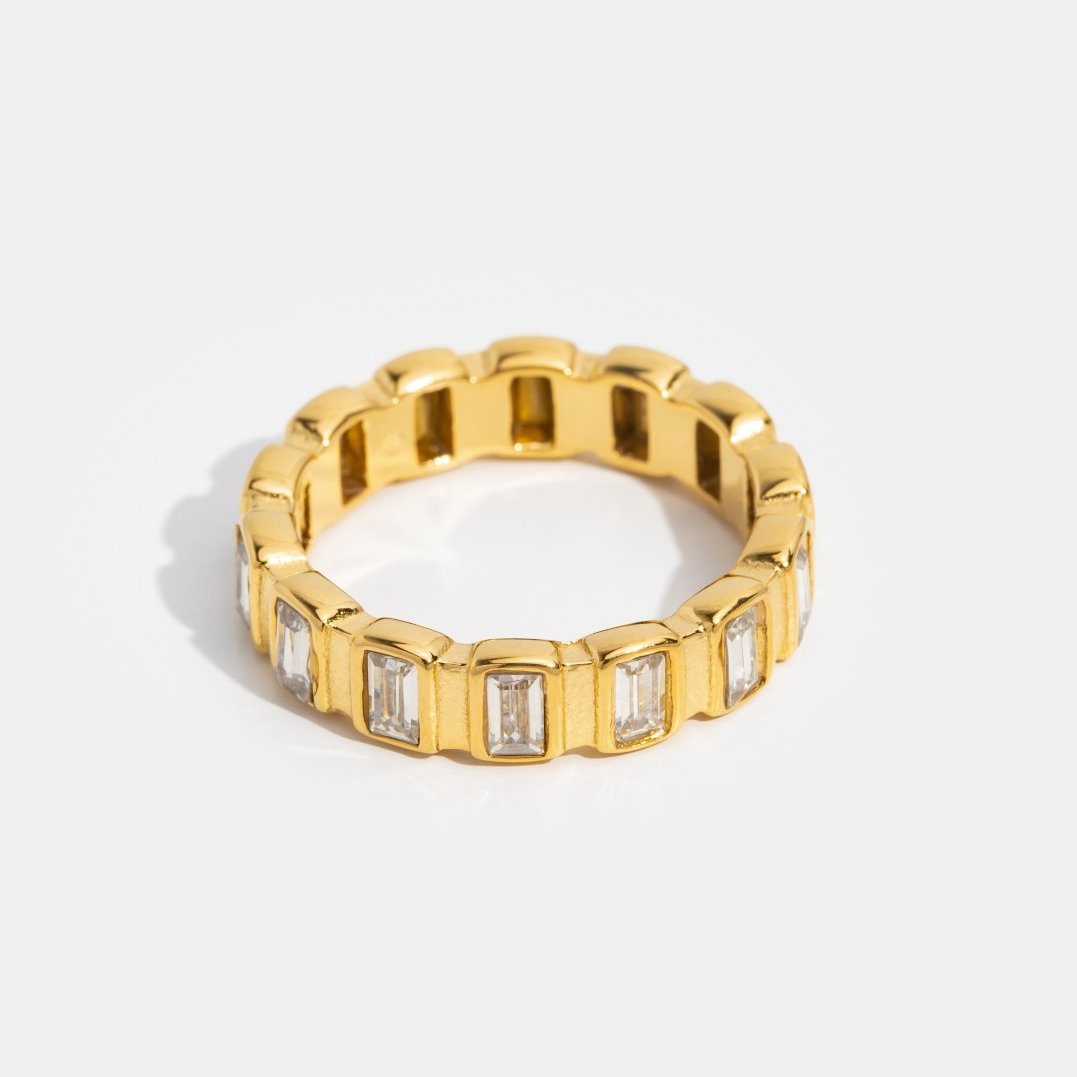 Gigi Square Crystal Ring, standing upright on white, gold band with rectangular clear stones