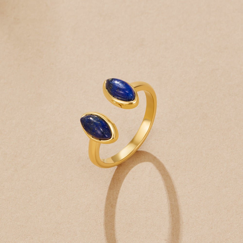 Gold Lapis Lazuli Wrap Ring, open gold ring on beige surface with two marquise blue stones