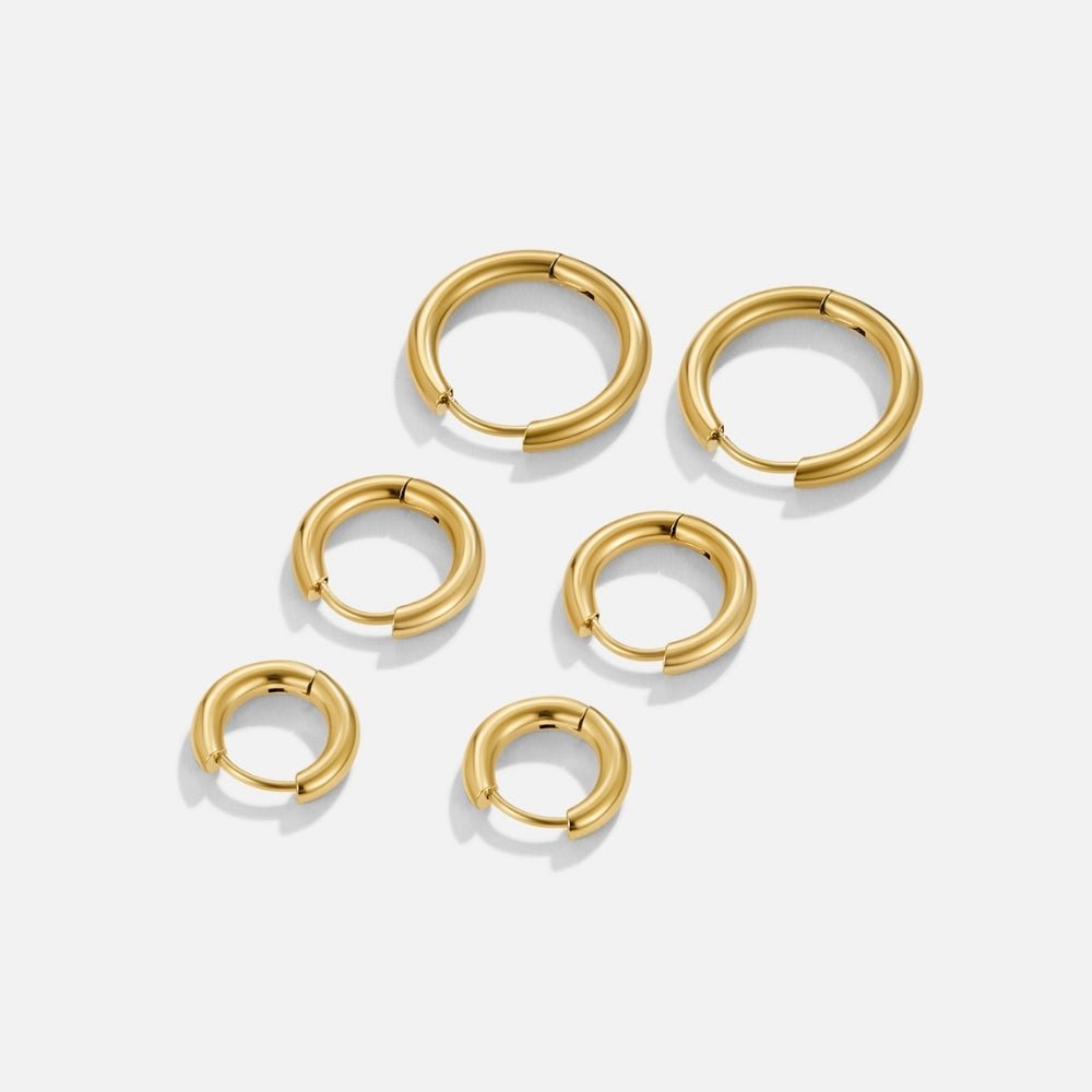 Gold Trio Mini Hoop Set, six polished gold hoops in three sizes, laid flat on white