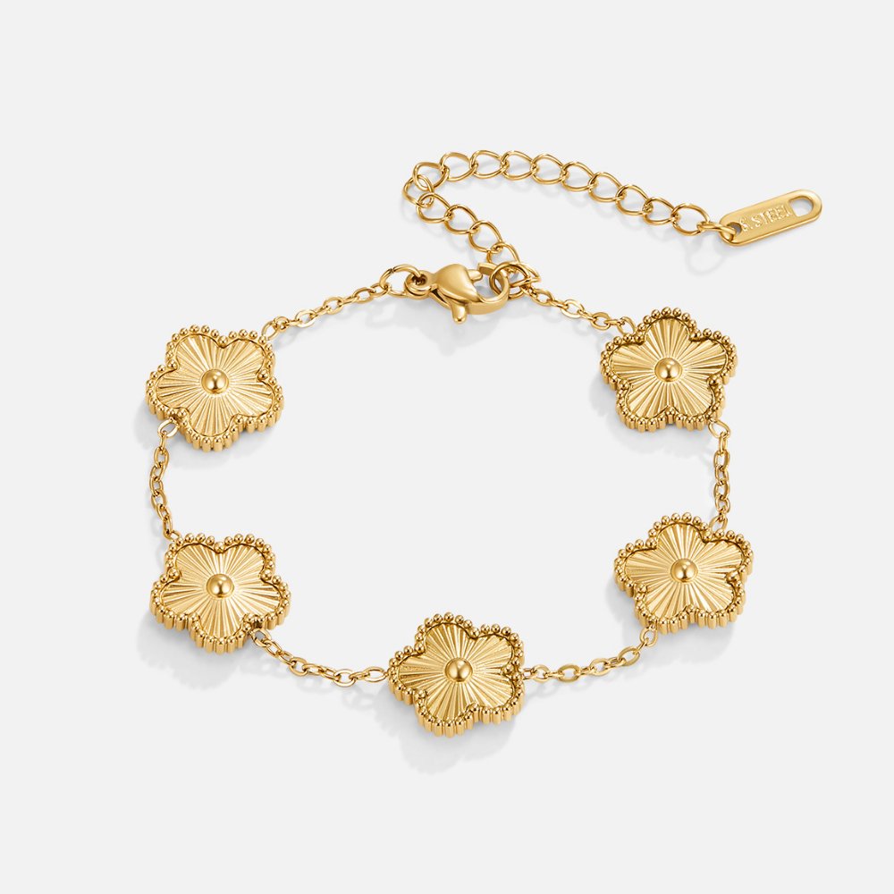 Golden Clover Bracelet, flat lay of gold bracelet with five clover motifs and extender chain
