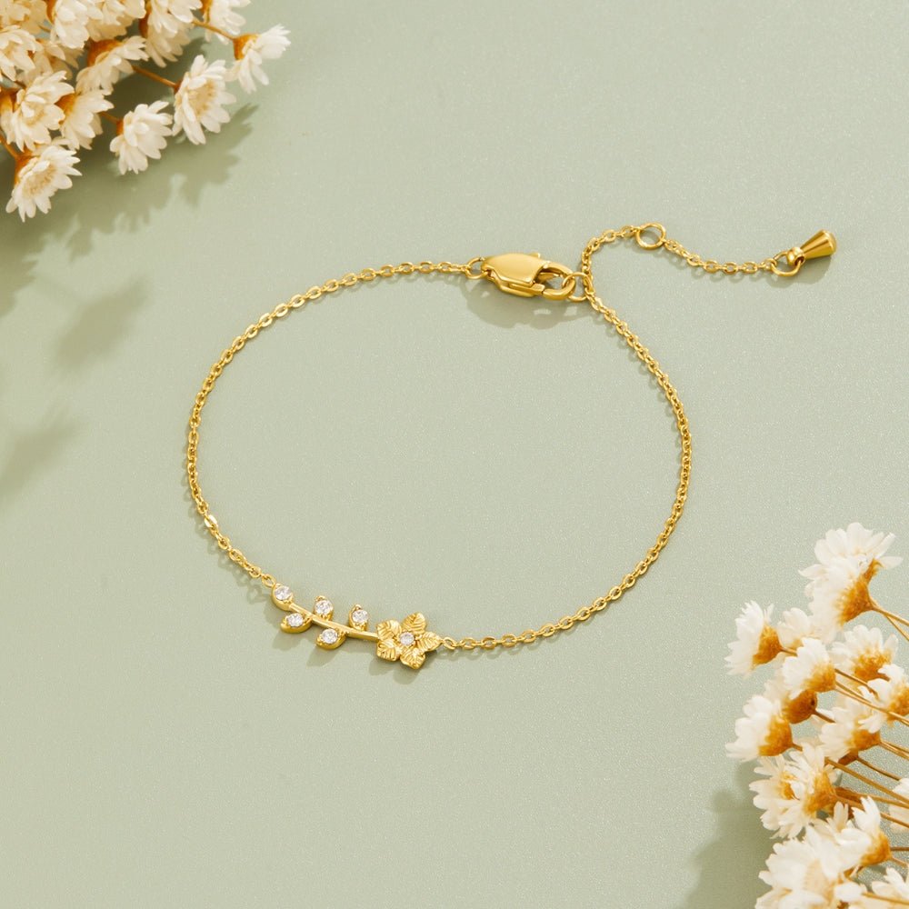 Golden Crystal Vine Bracelet, laid flat on sage green with dried flowers, gold leaf and flower