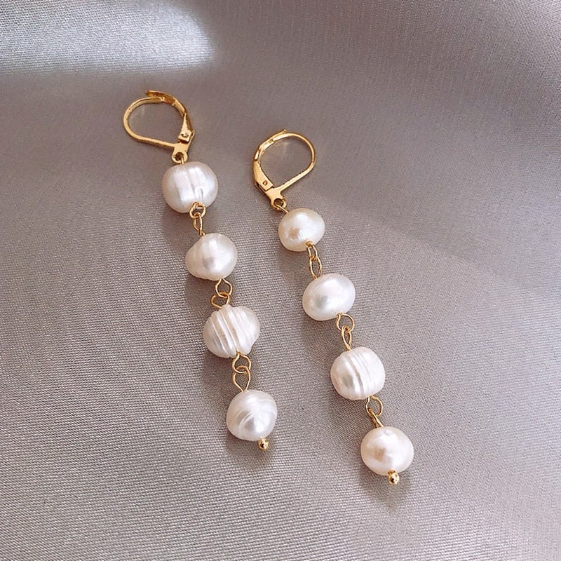 Golden Freshwater Pearl Earrings, a pair of drop earrings on grey satin, pearls on gold chain