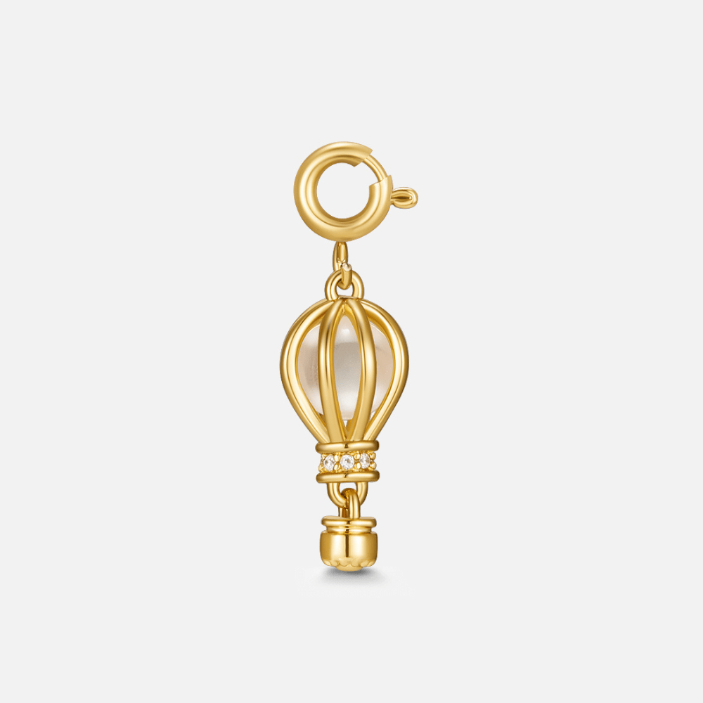 Golden Hot Air Balloon Charm, gold hot air balloon charm with a pearl inside, on a plain background