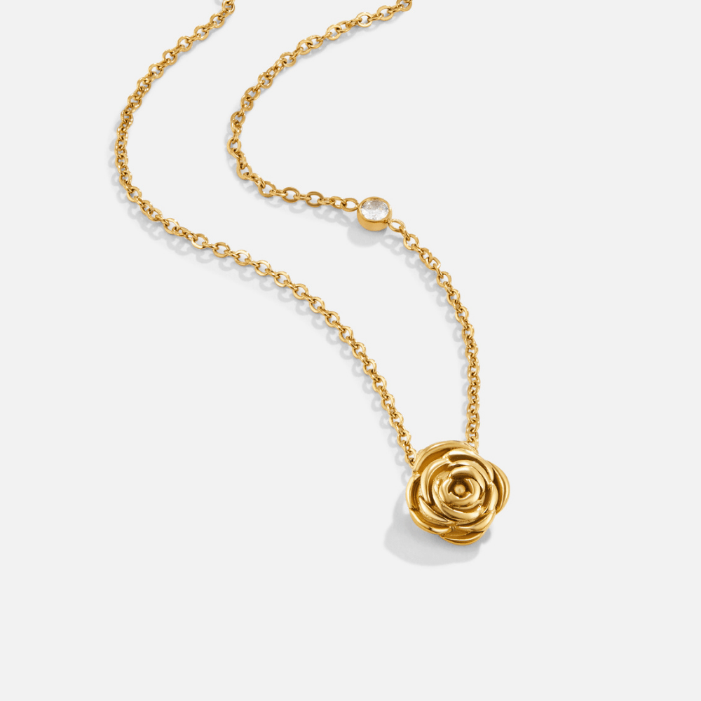 Golden Rose Pendant Necklace, gold chain with a rose pendant and small clear stone on white