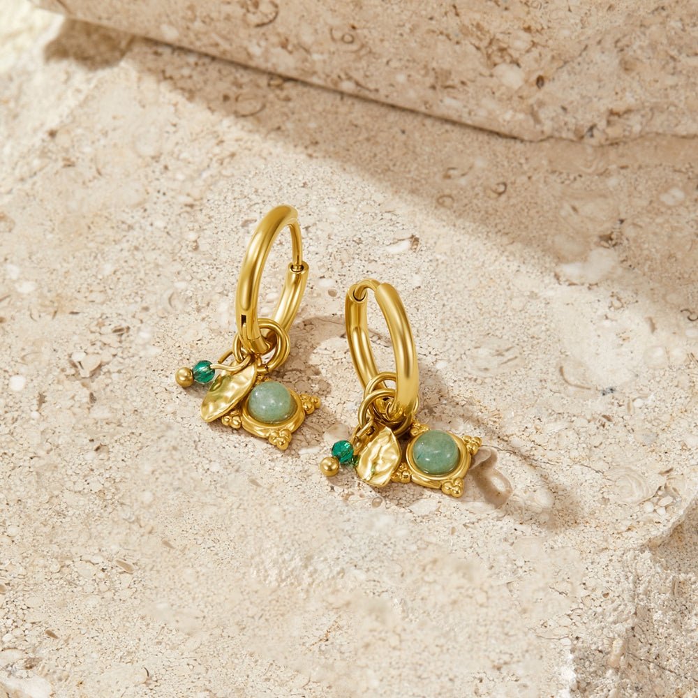 Green Aventurine Charm Earrings, a pair of gold hoop earrings with green stone charms on pale stone