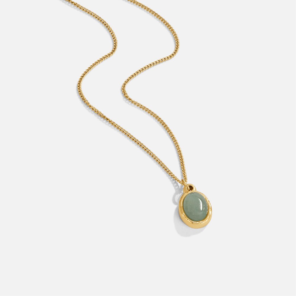 Green Aventurine Pendant Necklace, gold chain laid diagonally, with an oval green stone pendant