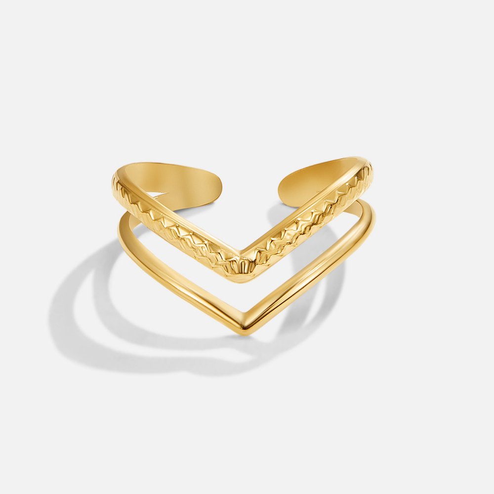 Harper Layered Wrap Ring, two gold V-shaped rings stacked, one textured and one smooth, on white