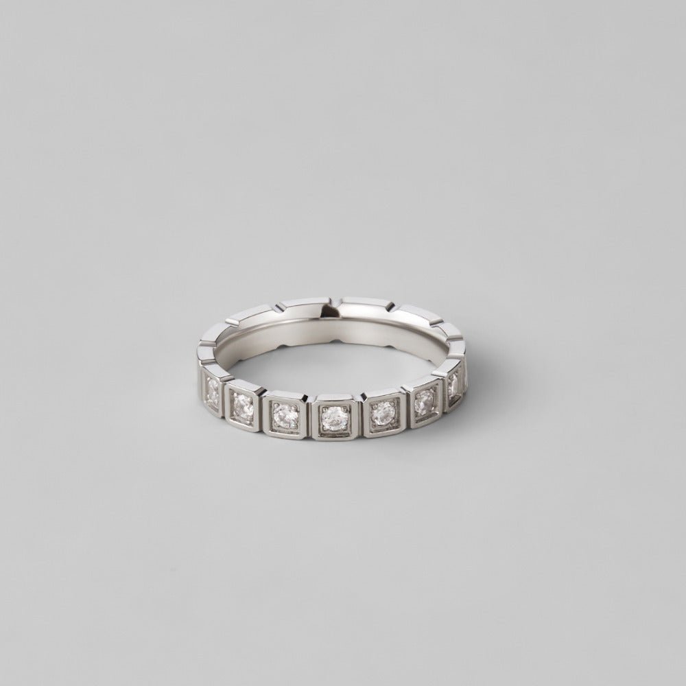 Hera Silver Crystal Ring, silver band with square-set clear stones, on plain grey surface