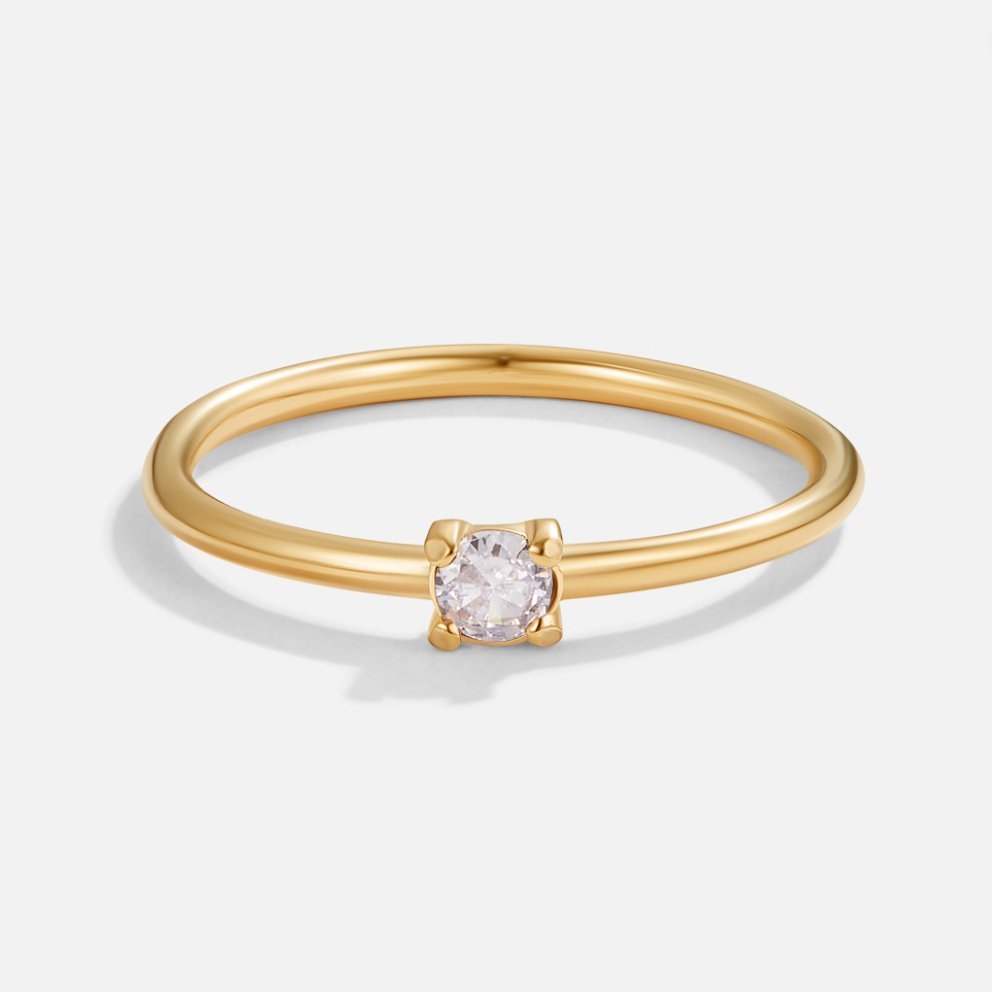 June Birthstone 18K Gold Ring, thin gold band with a small four-prong clear stone, on white