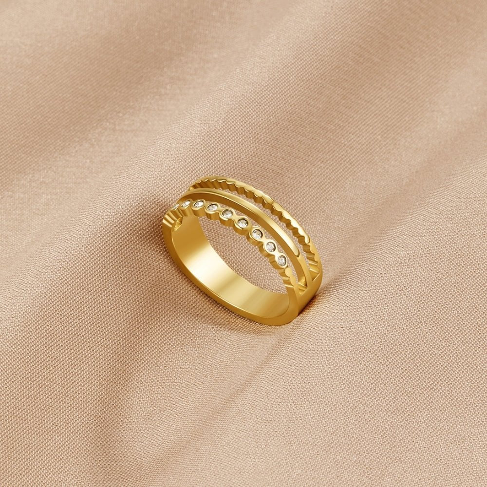 Layered Elowyn Crystal Ring, lying on beige satin with a row of small crystals