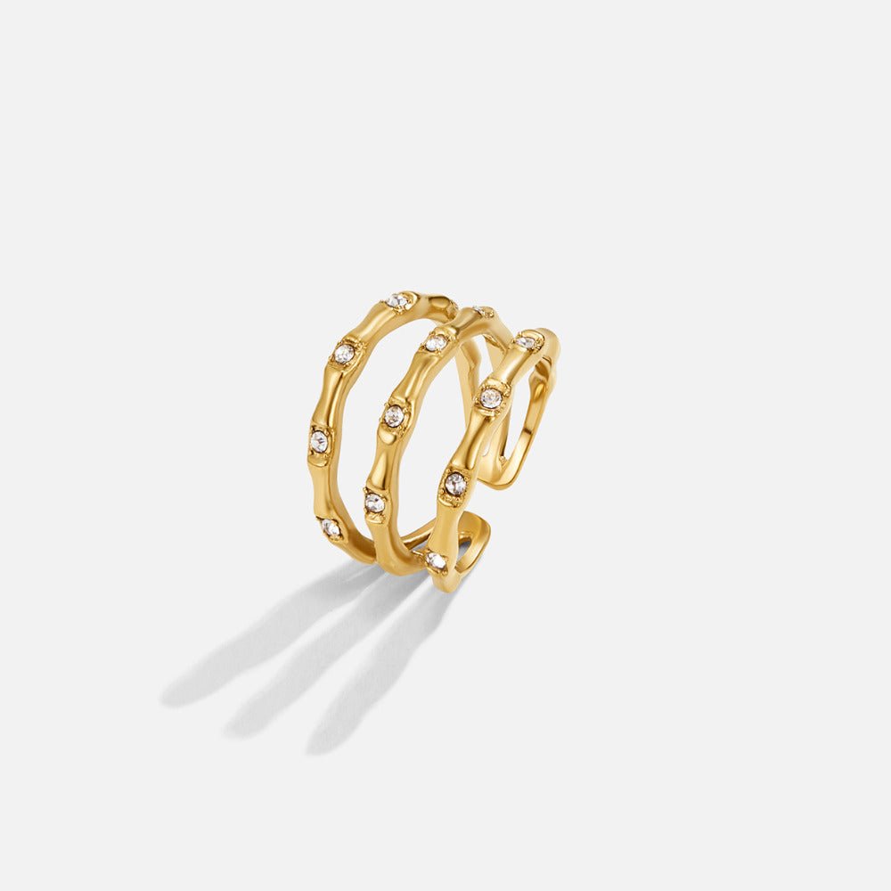 Layered Golden Bamboo Ring, three gold bands with small crystal stones, on white background