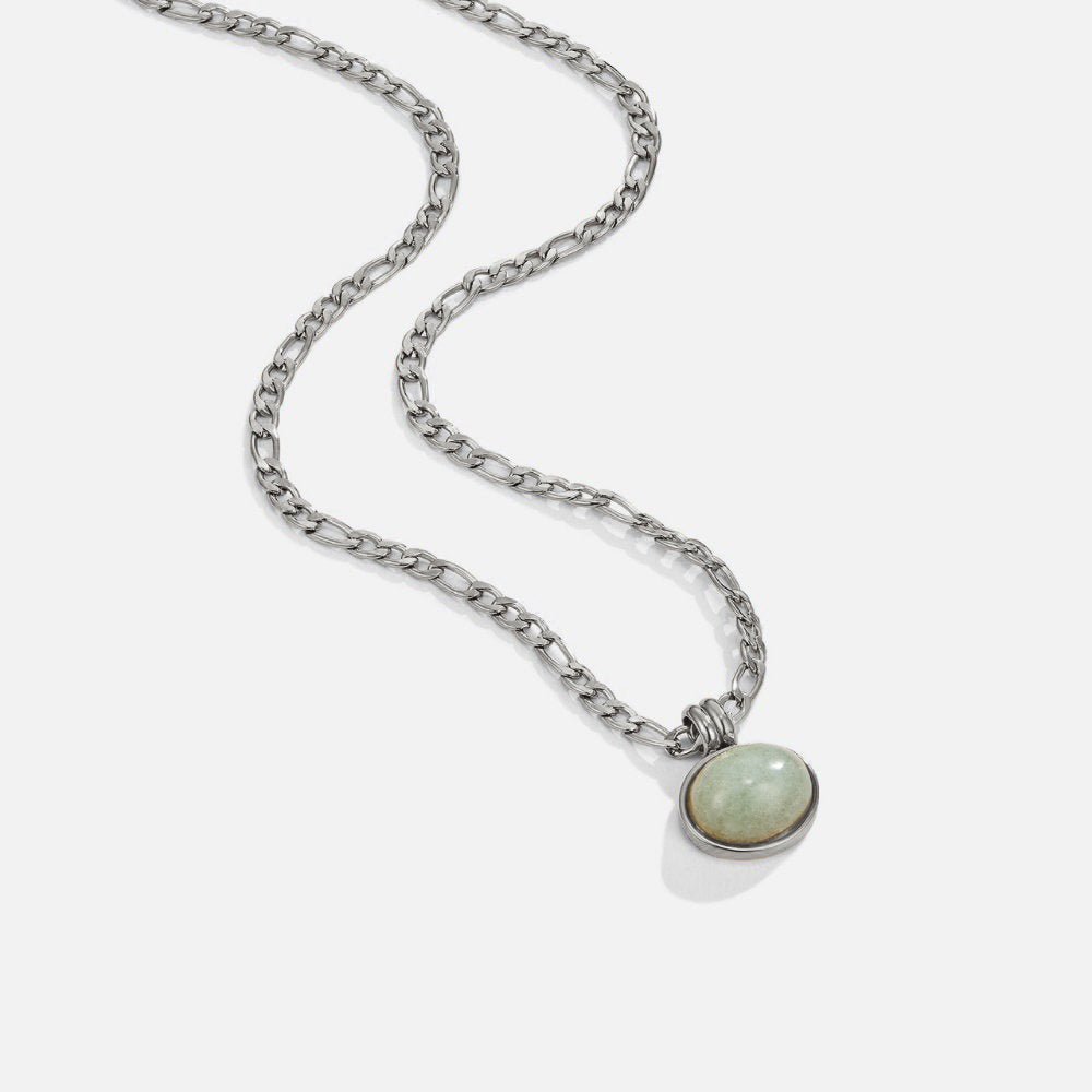 Liza Jade Pendant Silver Necklace, silver chain necklace laid out with a pale green oval pendant