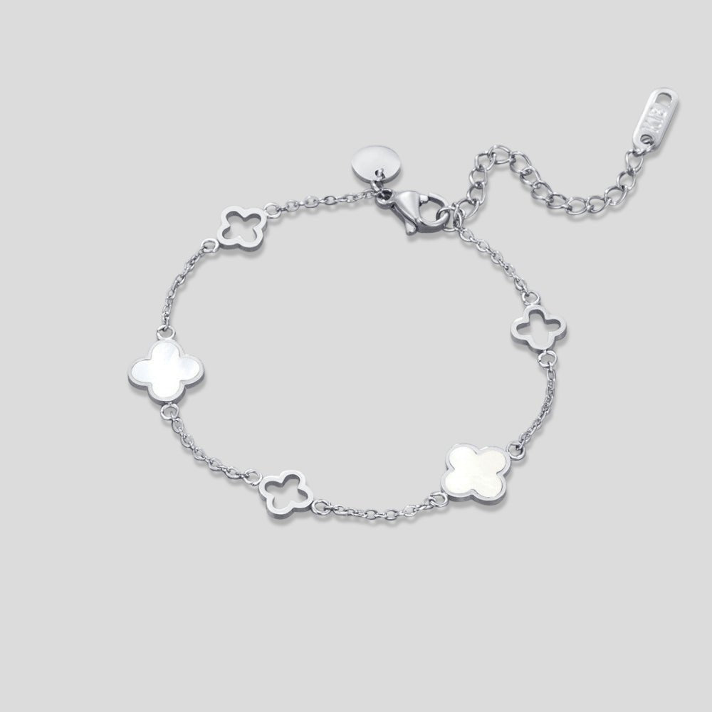 Lucia Silver Clover Bracelet, flat lay of a silver chain bracelet with clover charms