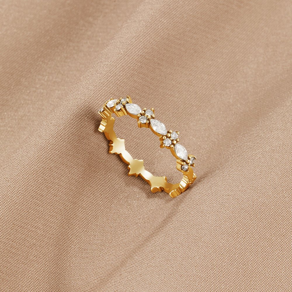Luxe Crystal Gold Ring, gold band with marquise and round crystals, resting on beige fabric