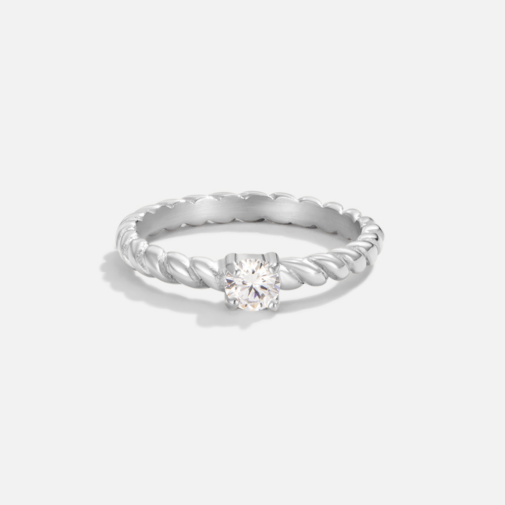 Milan Twisted Silver Crystal Ring, ring lying flat on plain light grey background, close view