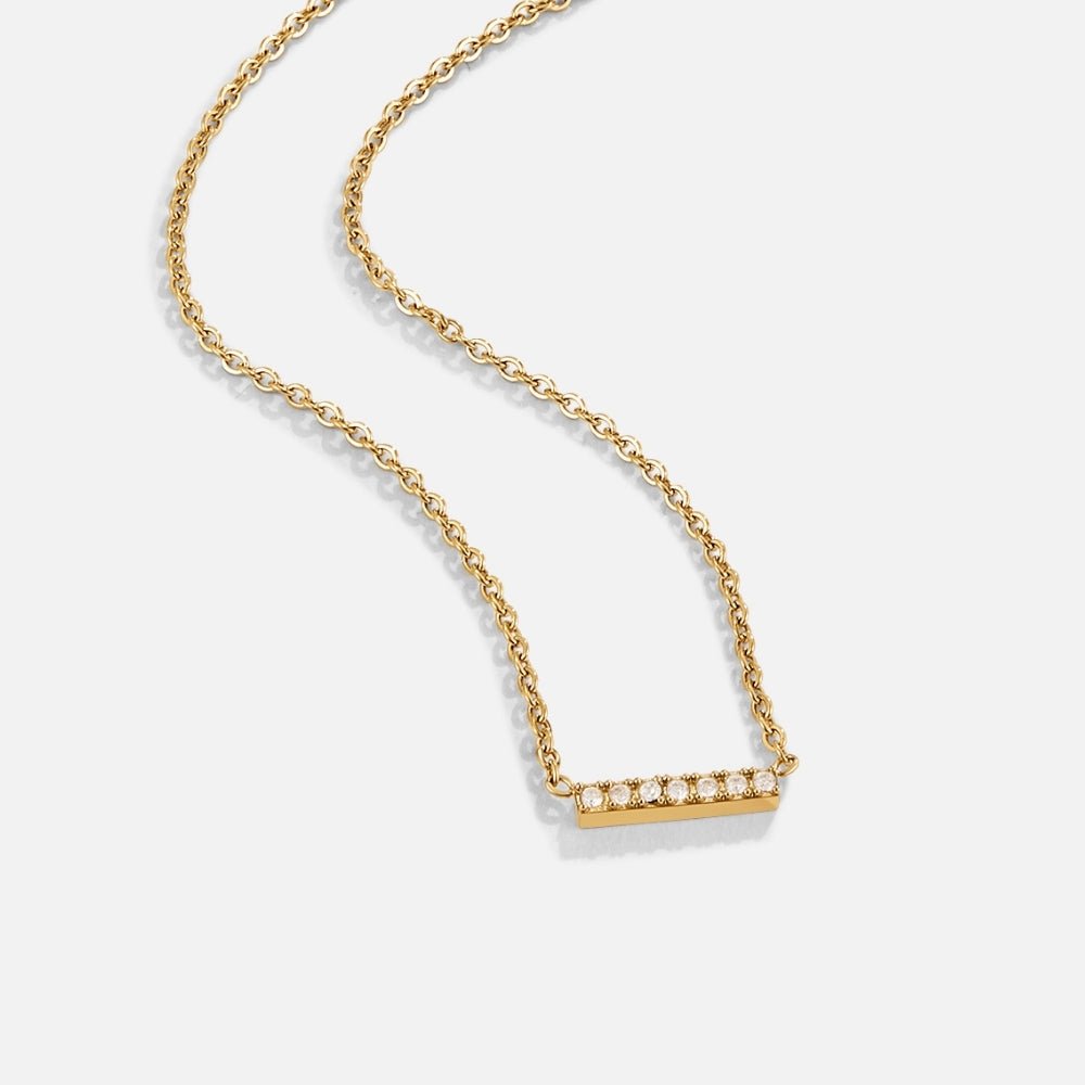 Missy Crystal Bar Pendant Necklace, gold chain laid flat with a bar pendant set with clear stones