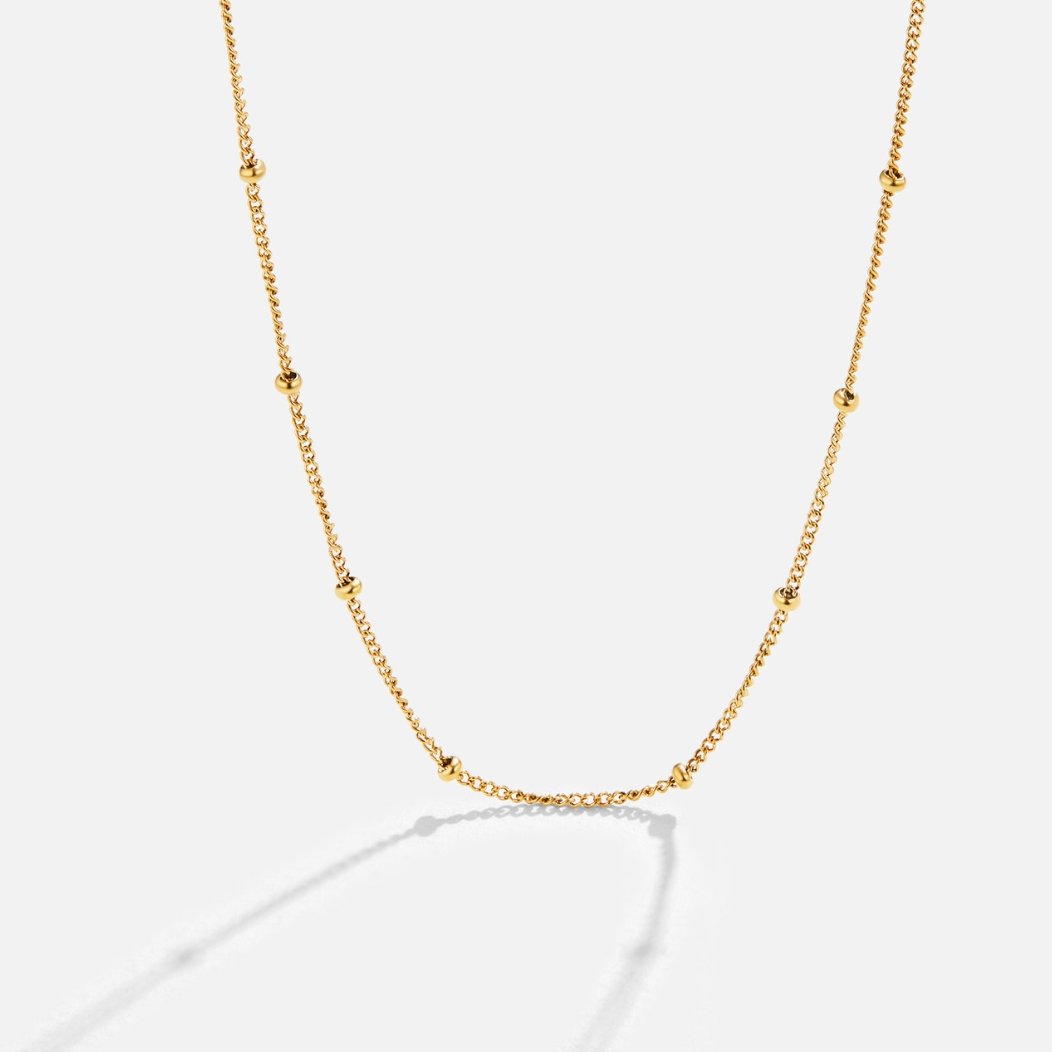 Niyah Bead Gold Chain Necklace, gold chain with small evenly spaced beads on white background
