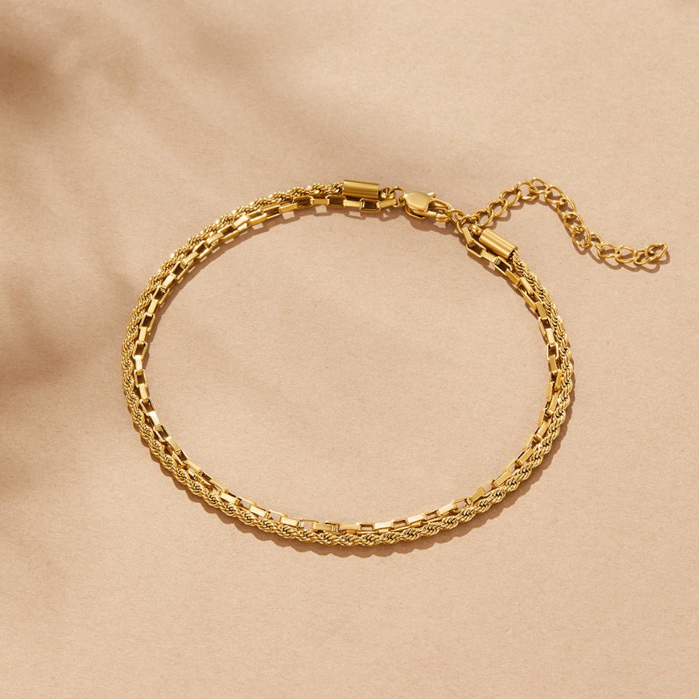 Nora Layered Box Chain Anklet, flat lay on beige fabric, two gold chains with clasp and