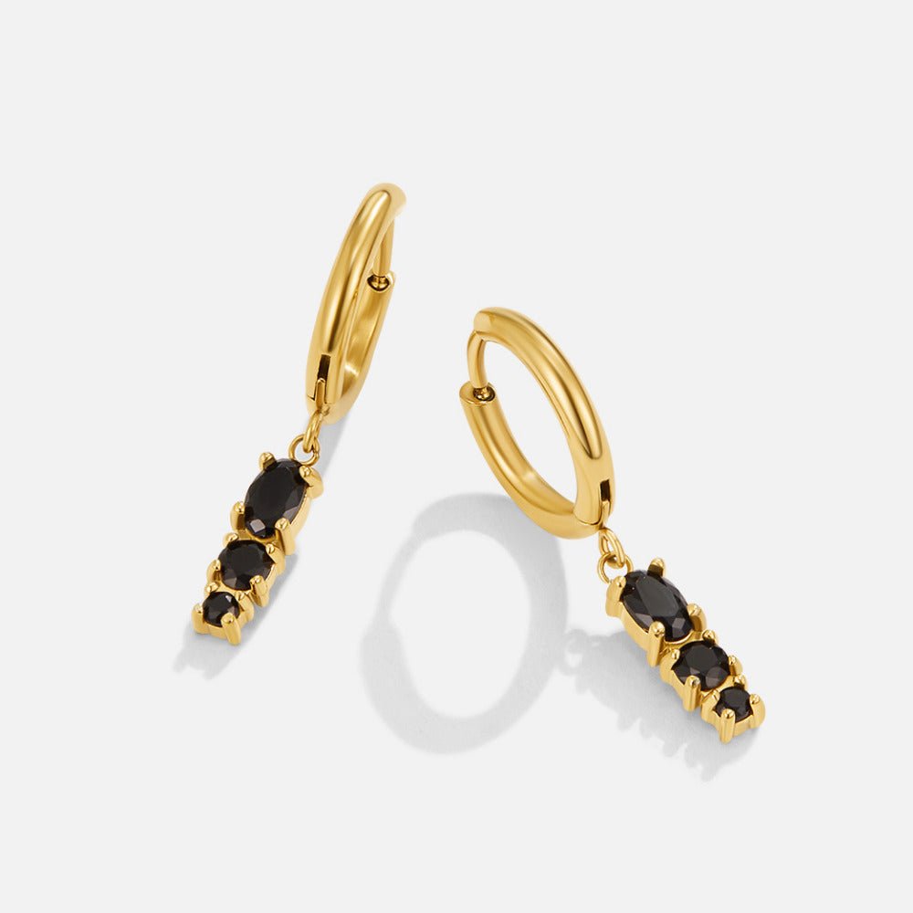 Obsidian Drop Hoop Earrings, a pair of gold hoop earrings with black stones dangling below, on white