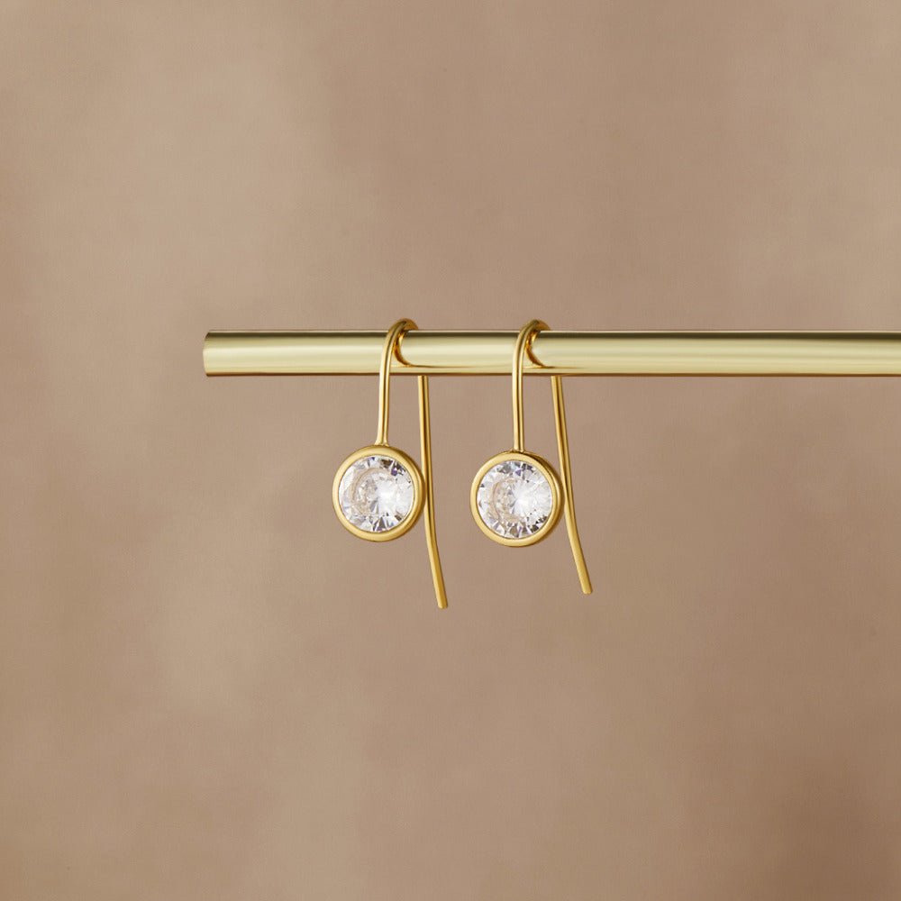 Olivia Crystal Drop Earrings, pair of gold drop earrings hanging from a gold bar, round clear stones