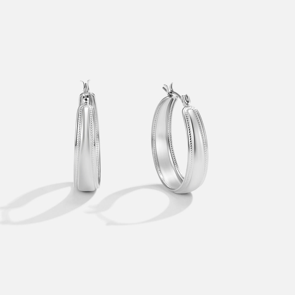 Orelia Silver Hoop Earrings, pair of silver hoop earrings on a light grey background, shown at