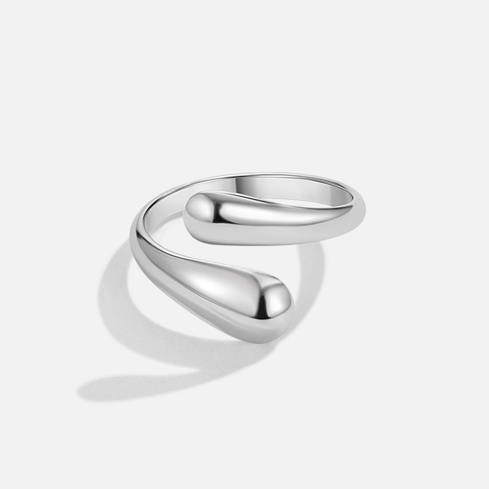 Raven Silver Wrap Ring, polished silver wrap ring on a white background, teardrop ends