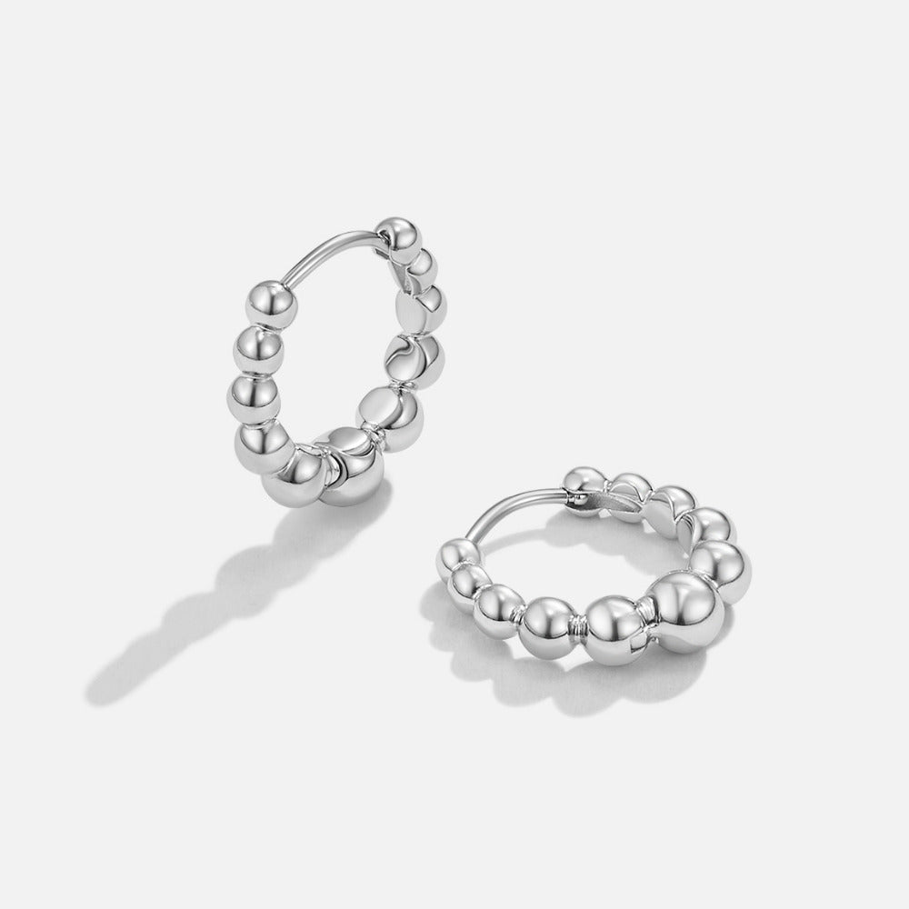 Roma Silver Hoop Earrings, pair of silver hoops with graduated beads on a white background