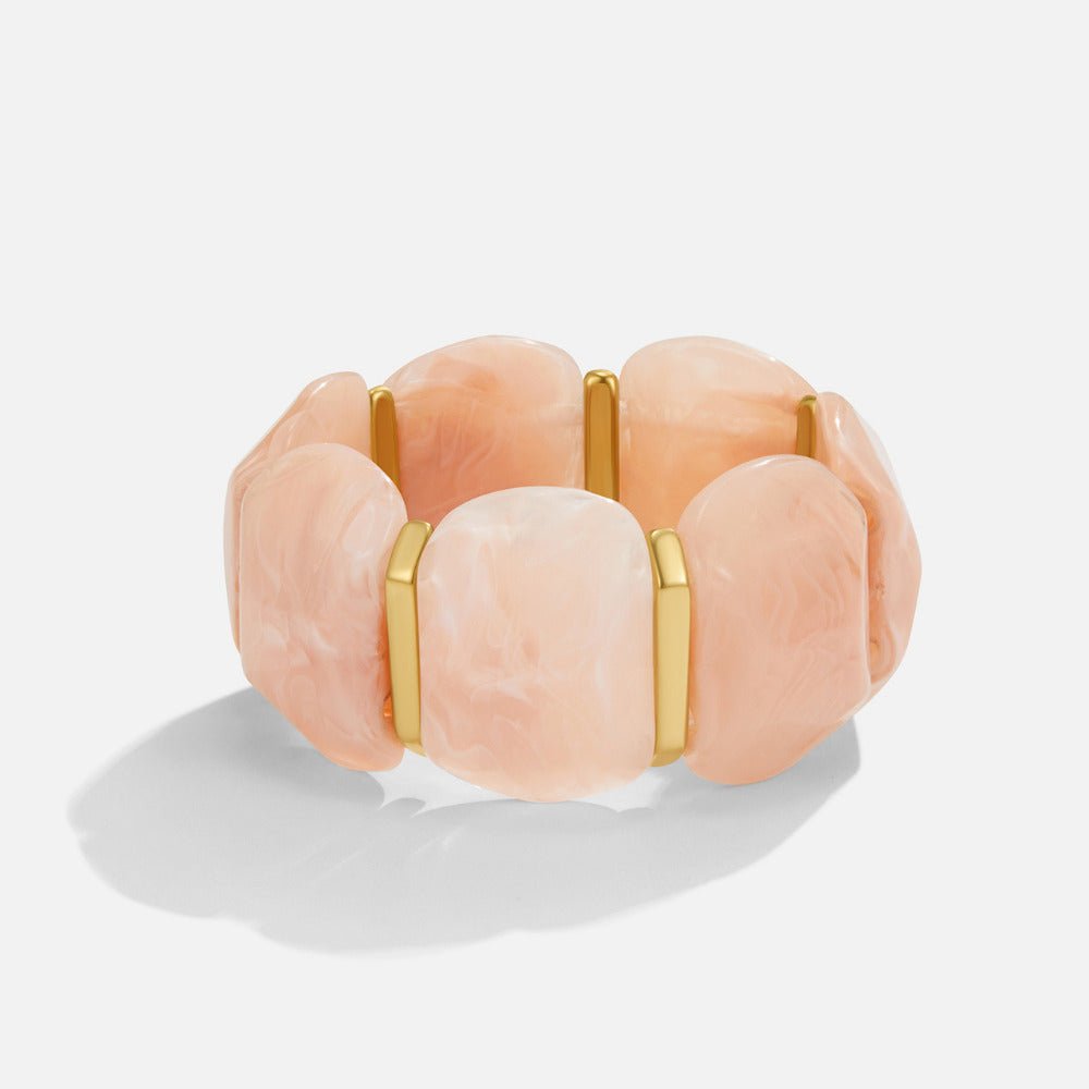 Rose Quartz Elastic Bracelet, stretch bracelet of marbled peach beads with gold spacers, on white