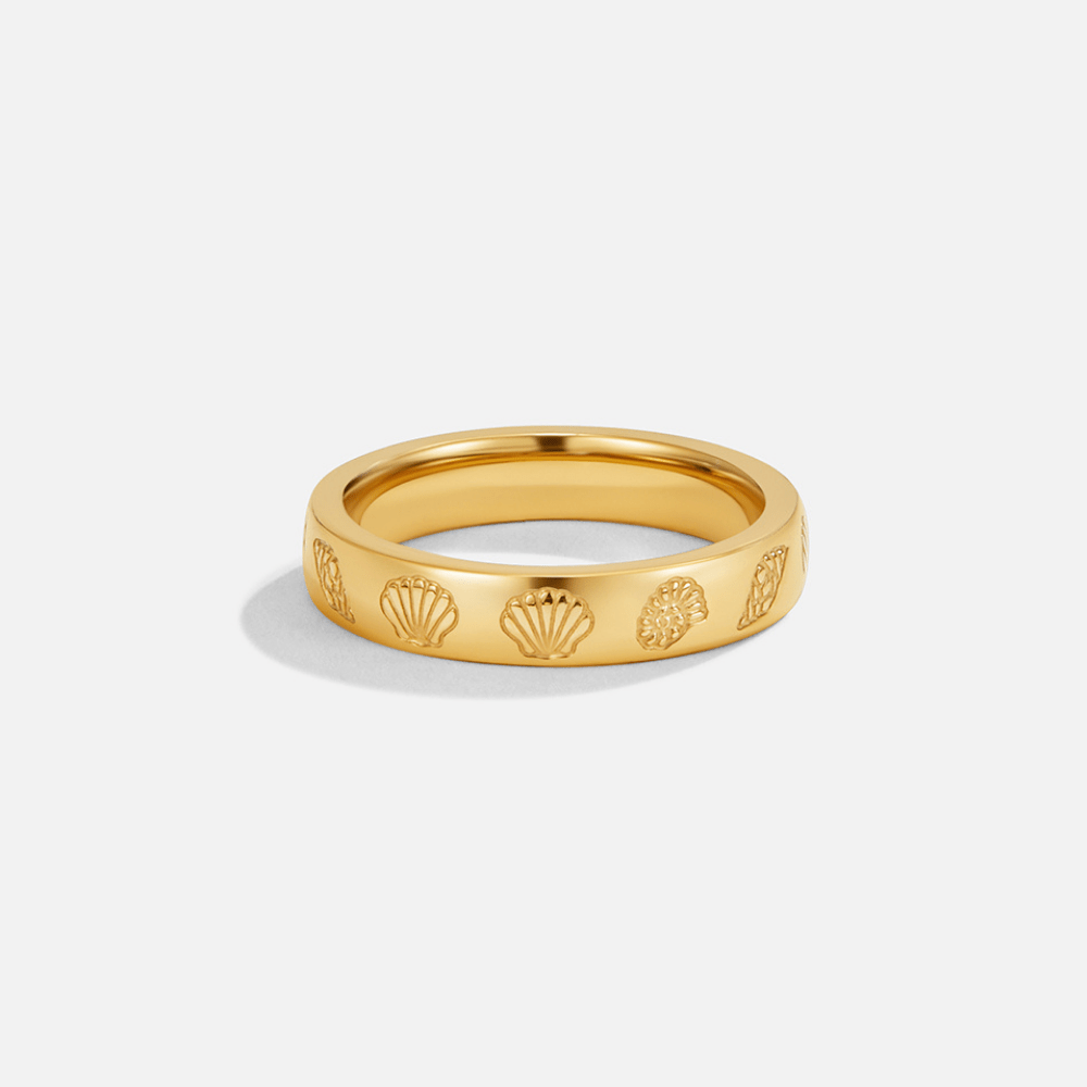 "Seascape" Engraved Gold Band Ring, standing upright on white, gold band with engraved shell motifs
