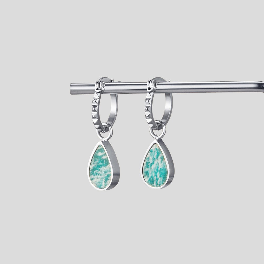 Silver Astoria Green Stone Hoop Earrings, pair of hoop earrings hanging from a metal rod