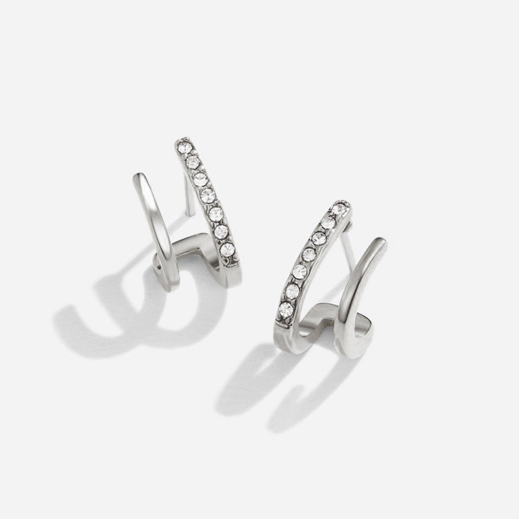 Silver & Crystal Claw Earrings, pair of silver earrings on white background, one with