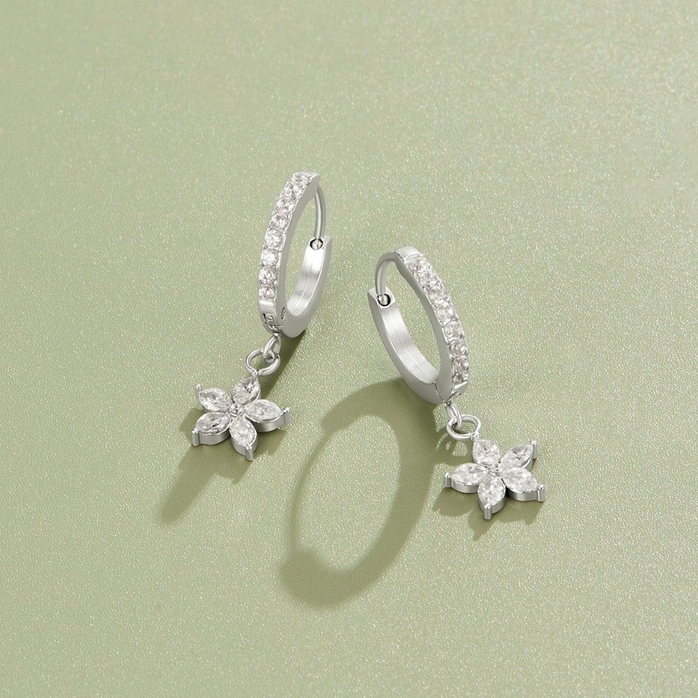 Silver Crystal Petal Drop Earrings, pair of hoop earrings with flower charms on a green surface