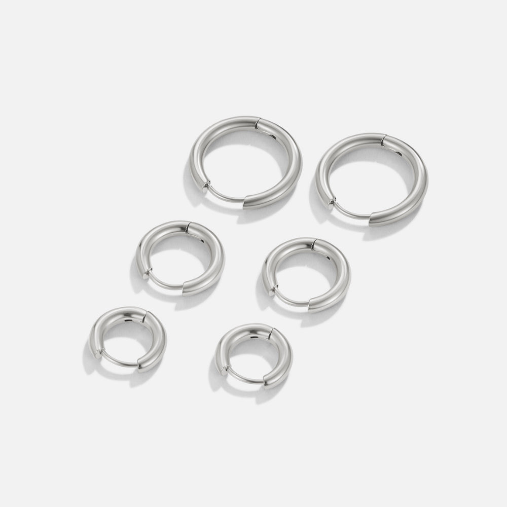 Silver Trio Mini Hoop Set, six polished silver hoops of three sizes laid out on white