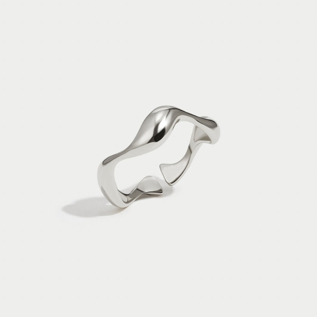 Silver Wave Ring, open wavy silver ring on a plain light background